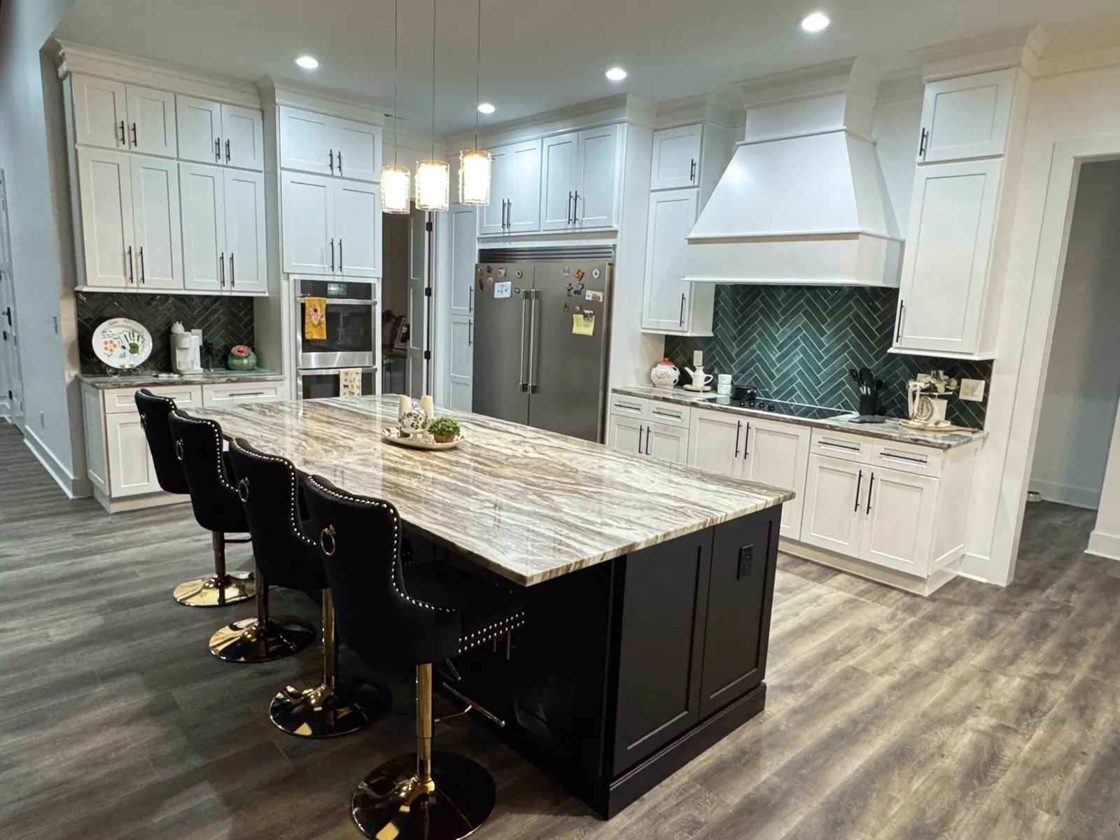 Kitchen with herringbone backsplash and marble island